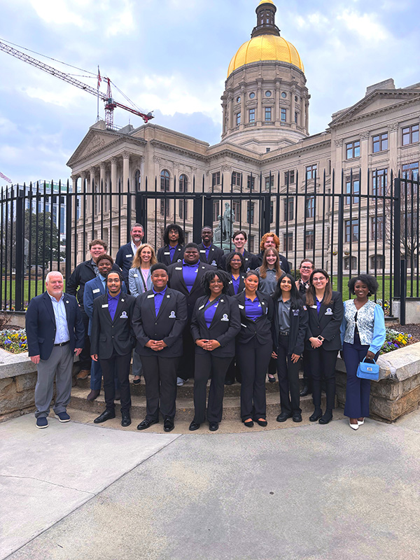Torch Society members posing in front of Georgia State Capitol